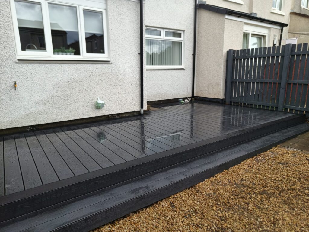 Completed garden deck with seating area and low-level lighting